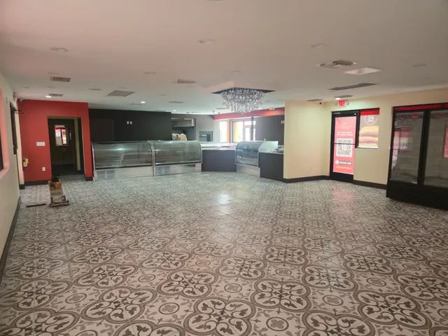 The finished Pinecrest Bakery sales floor, with refrigerated display cases, glass-door merchandisers and the completed ceiling air distribution in service