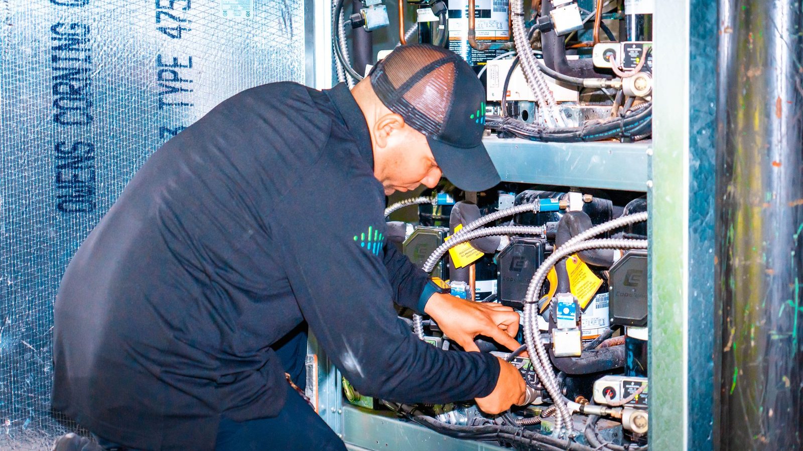 Technician carrying out preventive maintenance on a commercial refrigeration unit
