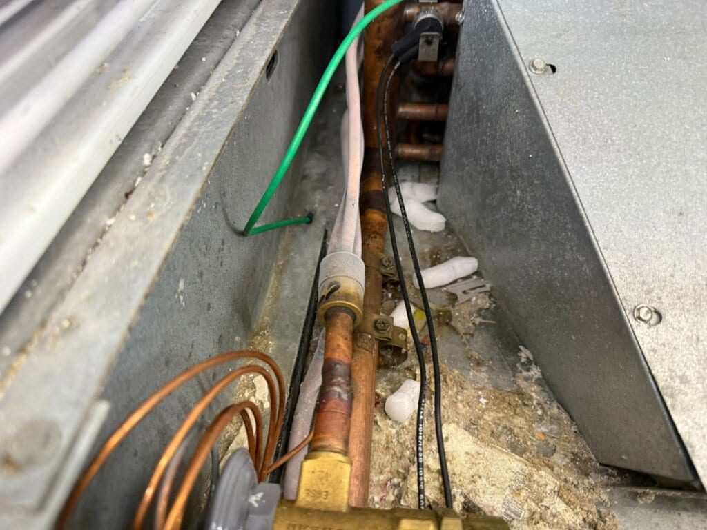 Corroded refrigerant lines, a common fault found in walk-in coolers and freezers